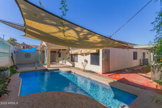 a view of a house with backyard and sitting area