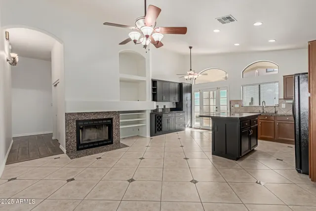 a kitchen with stainless steel appliances granite countertop a stove top oven and cabinets