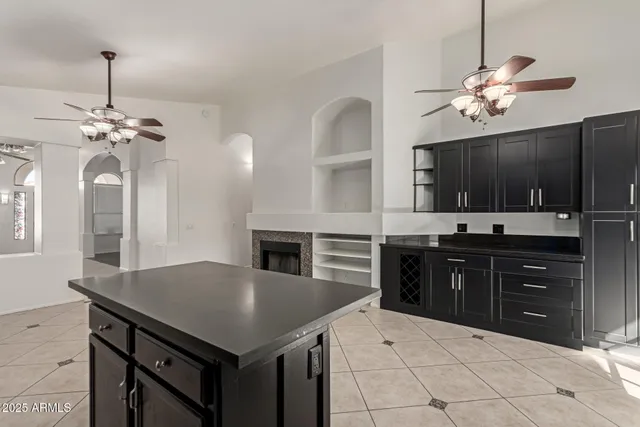 a kitchen with a kitchen island and stainless steel appliances