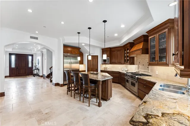 a spacious bedroom with a bed and a chandelier