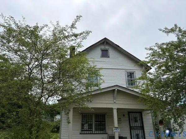 a view of a house with a tree and a yard