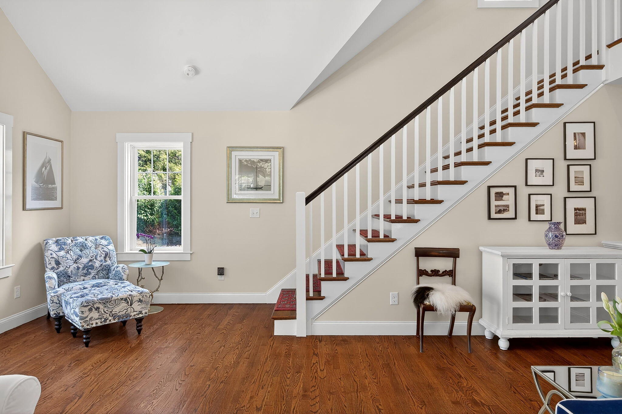 176 Bumps River Road Osterville, MA 02655 - Photo 28 of 54 a living room with furniture wooden floor and a book shelf