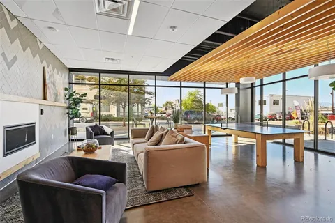 a living room with furniture and floor to ceiling windows