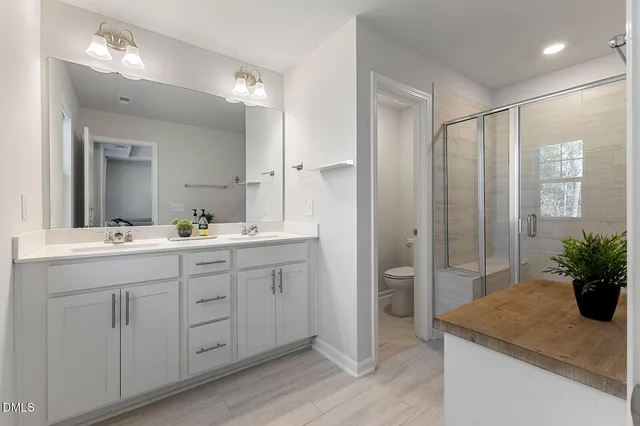 a bathroom with a granite countertop sink a mirror and a shower
