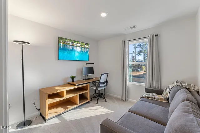 a reading room with furniture and a window