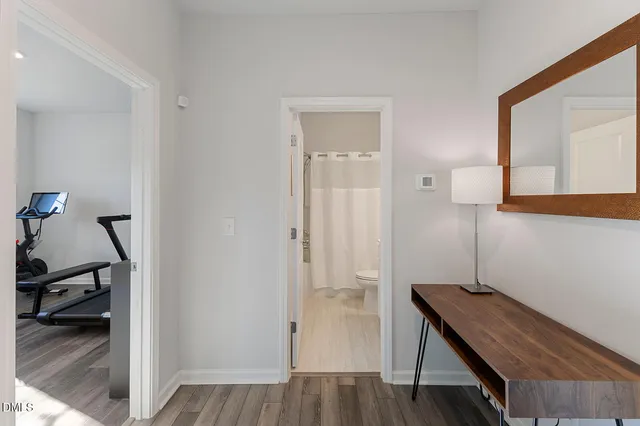 a view of a workspace with furniture and wooden floor