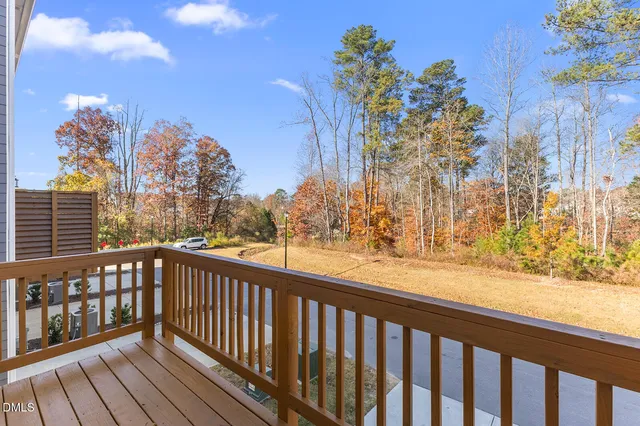 a view of a balcony with wooden fence