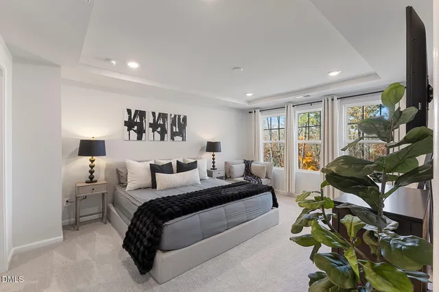 a bedroom with bed and a large window