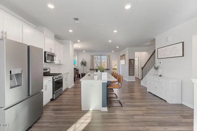 a kitchen with stainless steel appliances refrigerator microwave and stove