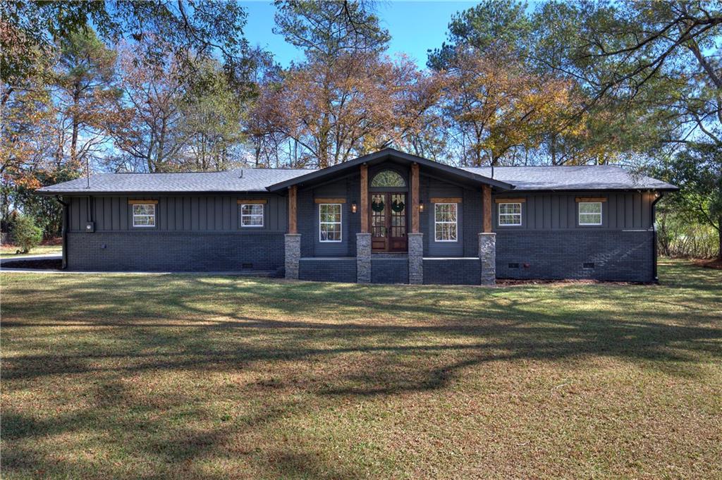 133 Kentucky Drive Northeast Calhoun, GA 30701 - Photo 1 of 1 a front view of a house with a yard