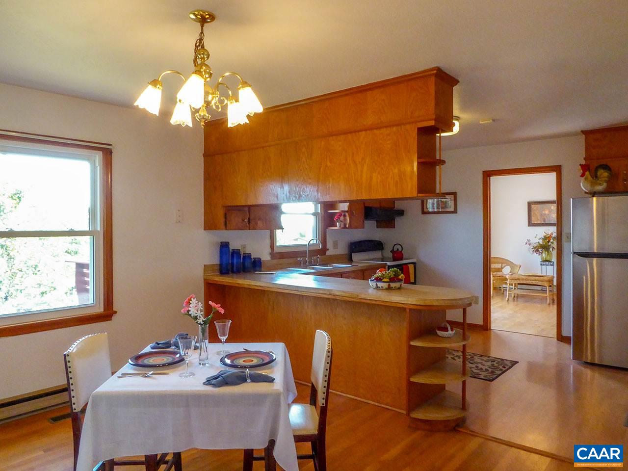 2656 Dunnes Shop Road Ruckersville, VA 22968 - Photo 8 of 27 a dining room with a table chairs and a chandelier