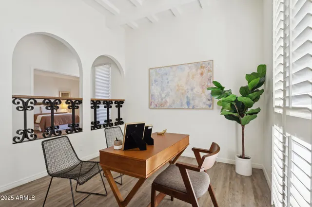 a bedroom with a large bed and a wooden floor