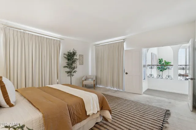 a bedroom with a bed and a potted plant