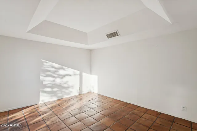 a view of a living room with wooden floor and a kitchen