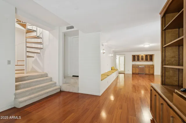 a view of a kitchen with wooden floor and electronic appliances