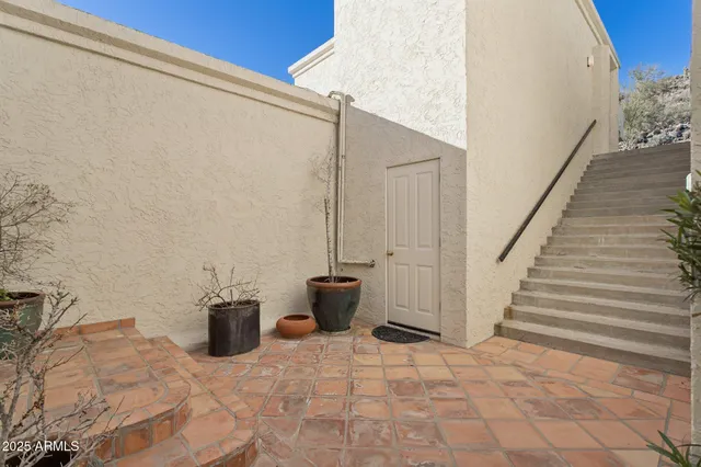 a living room with furniture a fireplace and a floor to ceiling window