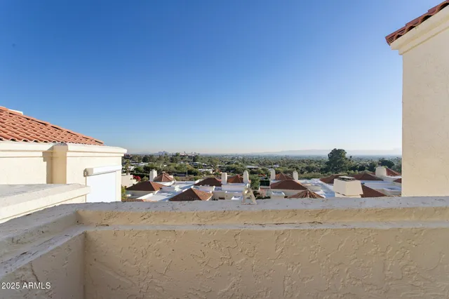 a balcony with wooden floor and fence
