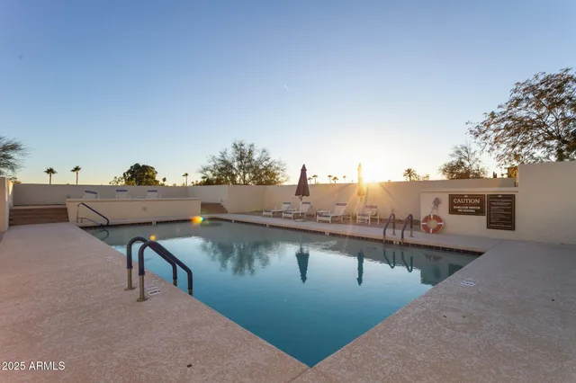 a picture of a room with a white wall and a refrigerator