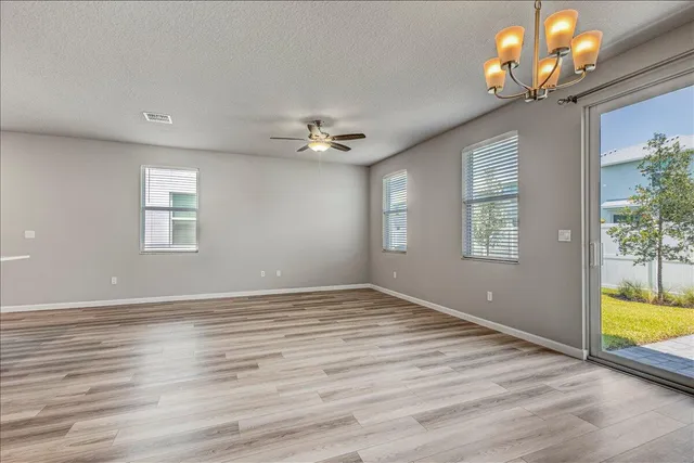 a view of kitchen with refrigerator microwave and stove