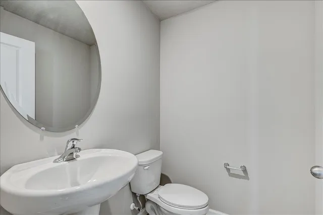 an empty room with a chandelier fan and windows