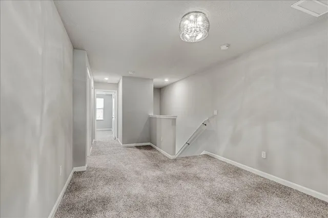 an empty room with a empty space and windows