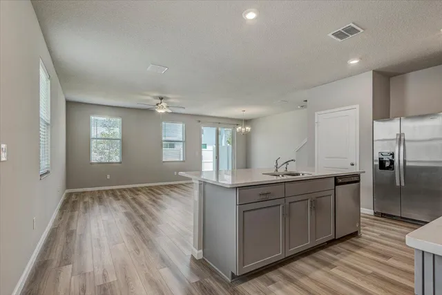 a kitchen with stainless steel appliances granite countertop a sink and cabinets