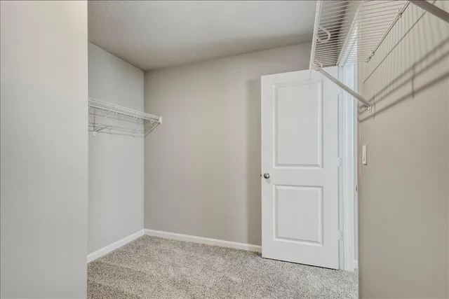 a en suite bathroom with a double vanity sink a mirror and a toilet