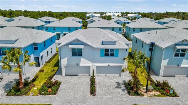 an aerial view of a house with swimming pool and outdoor seating