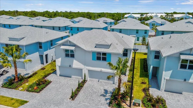a view of a house with pool and chairs
