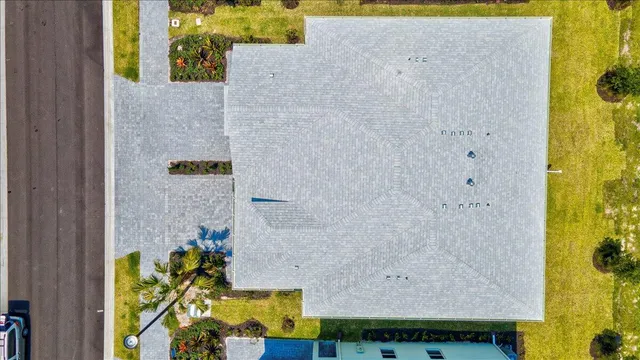 an aerial view of a house with a swimming pool