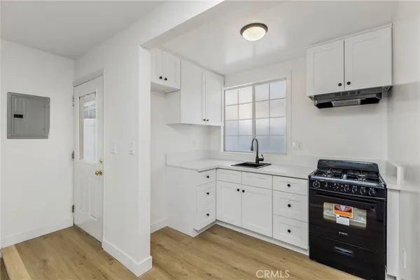 a kitchen with cabinets appliances and a window