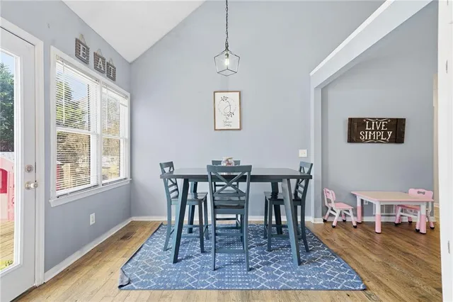 a view of a dining room with furniture and wooden floor