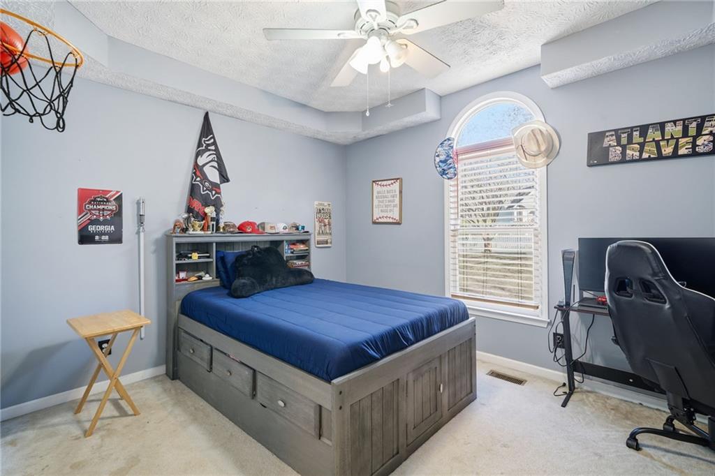 13 Timberline Drive Jasper, GA 30143 - Photo 19 of 39 a bedroom with a bed and a chandelier