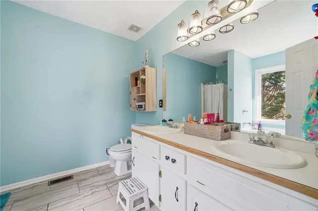 a white bath tub sitting in a bathroom next to a window