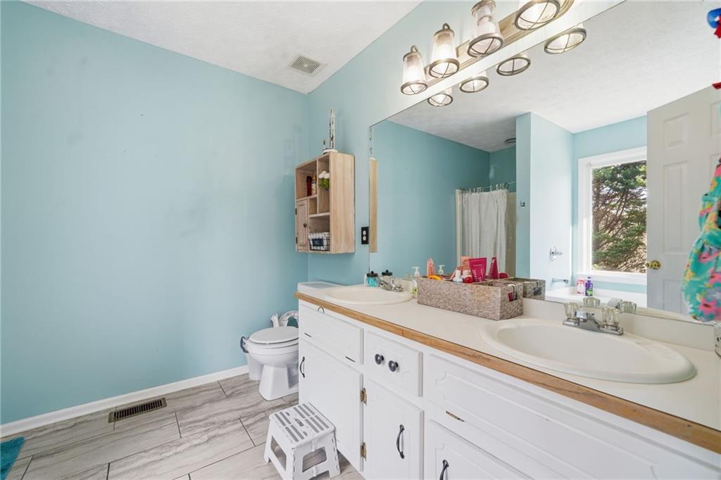 13 Timberline Drive Jasper, GA 30143 - Photo 24 of 39 a bathroom with a sink vanity mirror and toilet