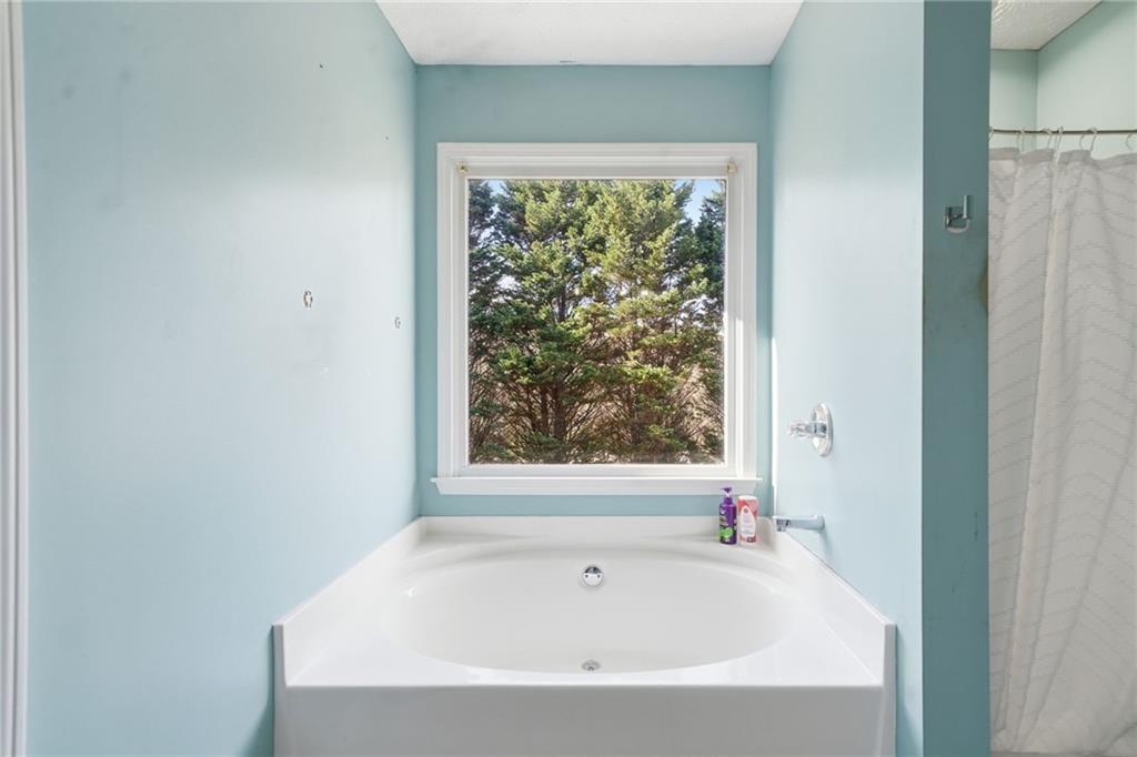 13 Timberline Drive Jasper, GA 30143 - Photo 25 of 39 a white bath tub sitting in a bathroom next to a window