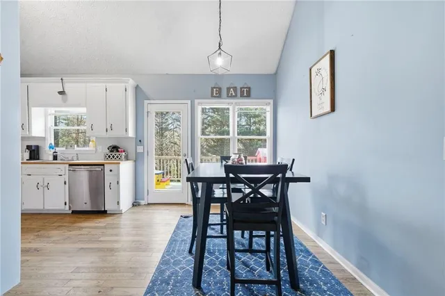 a view of a dining room with furniture and window