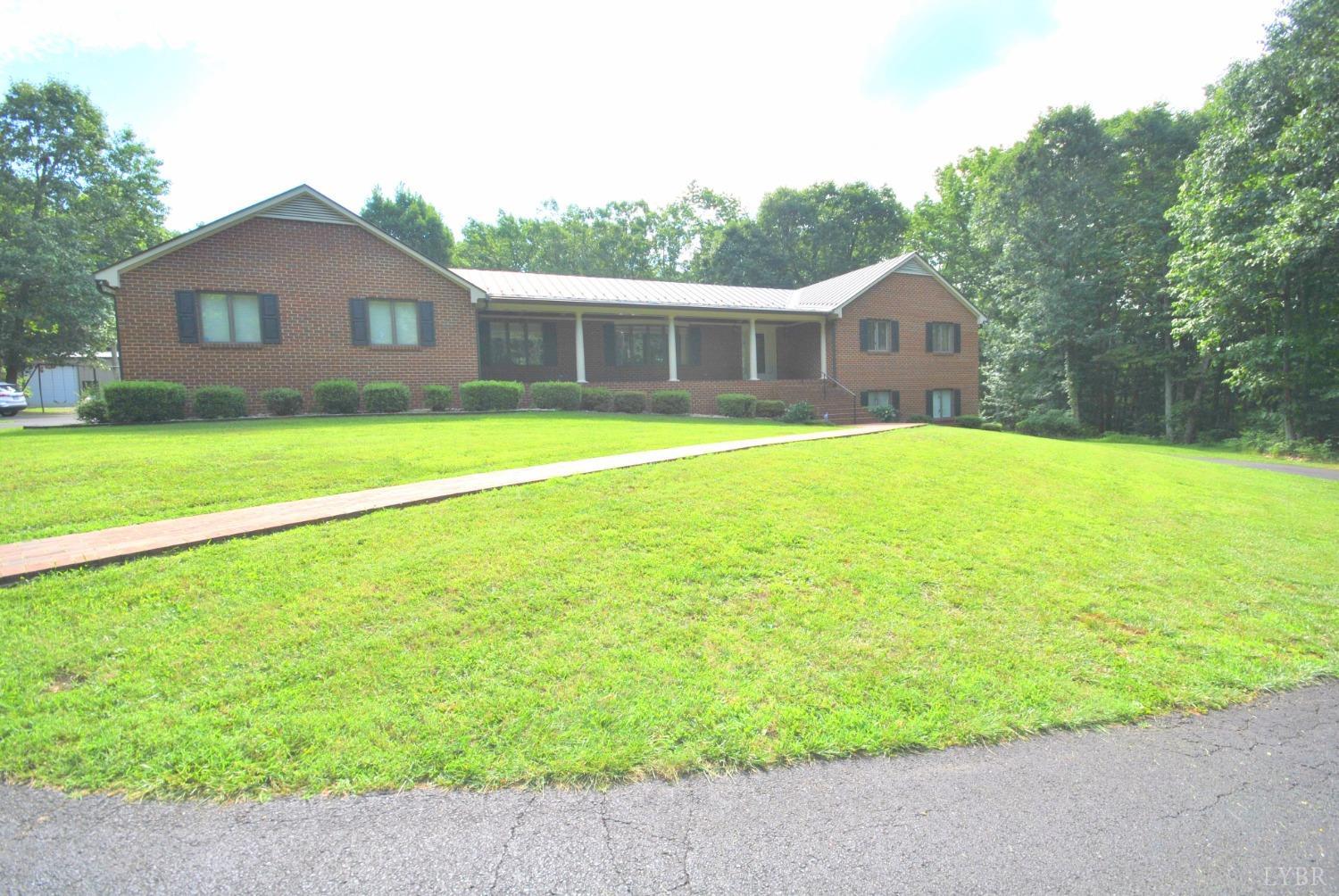 a front view of a house with a garden and yard
