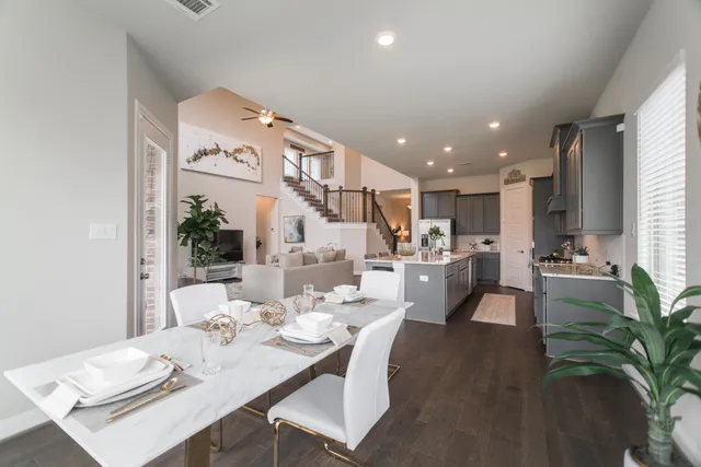 a dining room with furniture a kitchen view and a chandelier