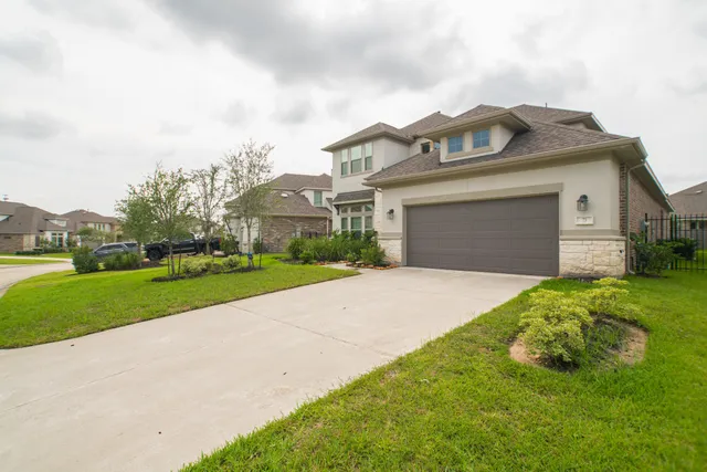 a front view of a house with a yard and garage