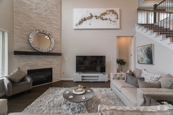 a living room with furniture a rug and a fireplace