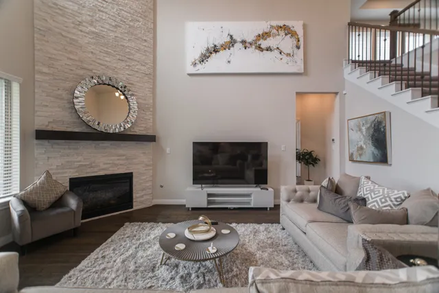 a living room with furniture a rug and a fireplace