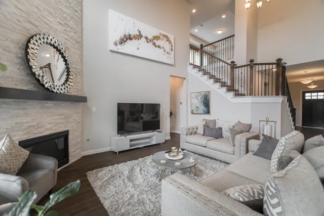 a living room with furniture a flat screen tv and a fireplace