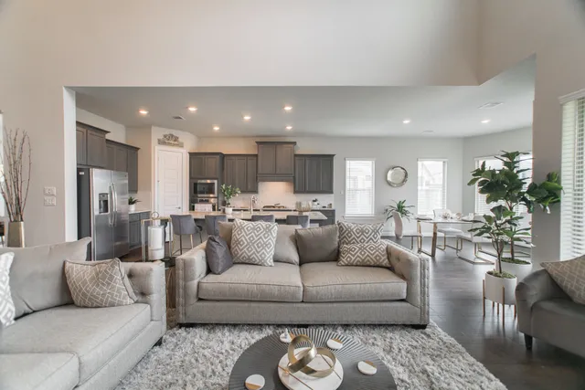 a living room with furniture and a view of kitchen