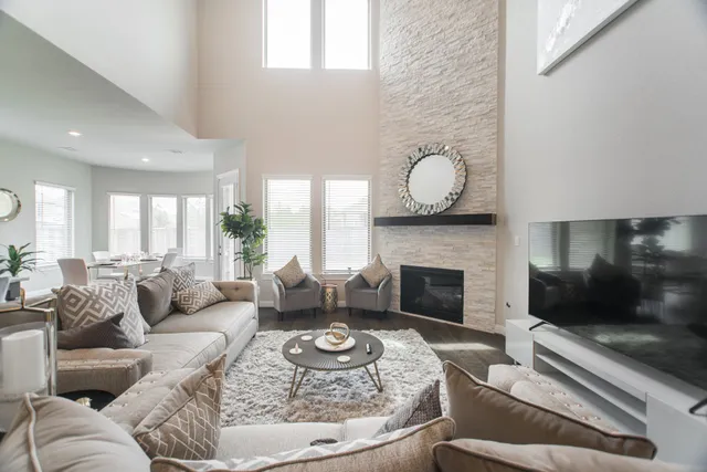 a living room with furniture a fireplace and a flat screen tv