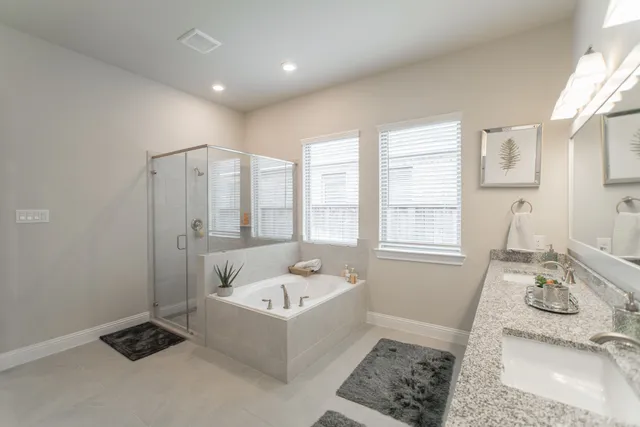 a bathroom with a tub sink and mirror