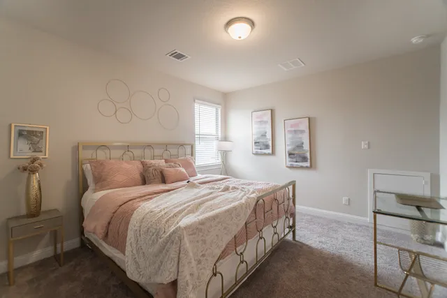 a bed room with a bed and chair