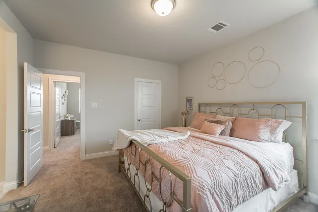 a bedroom with a bed and a mirror