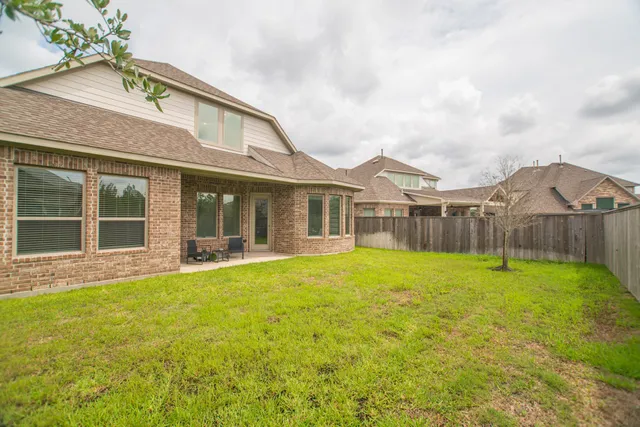 a view of a house with a yard and sitting area