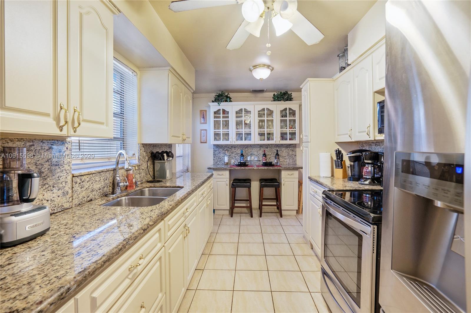 a kitchen with stainless steel appliances granite countertop a stove sink and cabinets